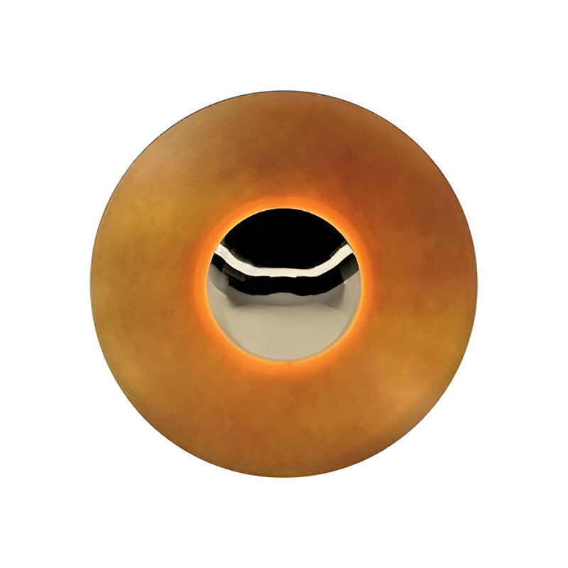 Light orange disc sconce with a chrome centre on a white ground