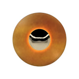 Light orange disc sconce with a chrome centre on a white ground