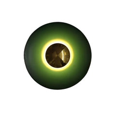 Green disc sconce with a gold centre lit on a white ground