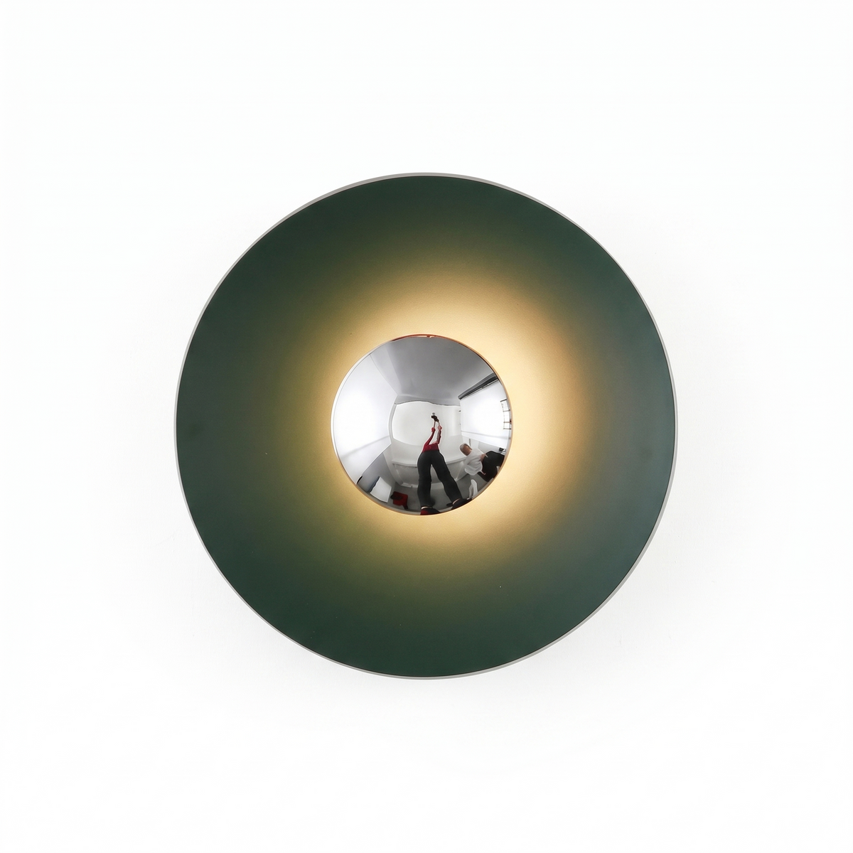 Green disc sconce with a chrome centre seen at an angle