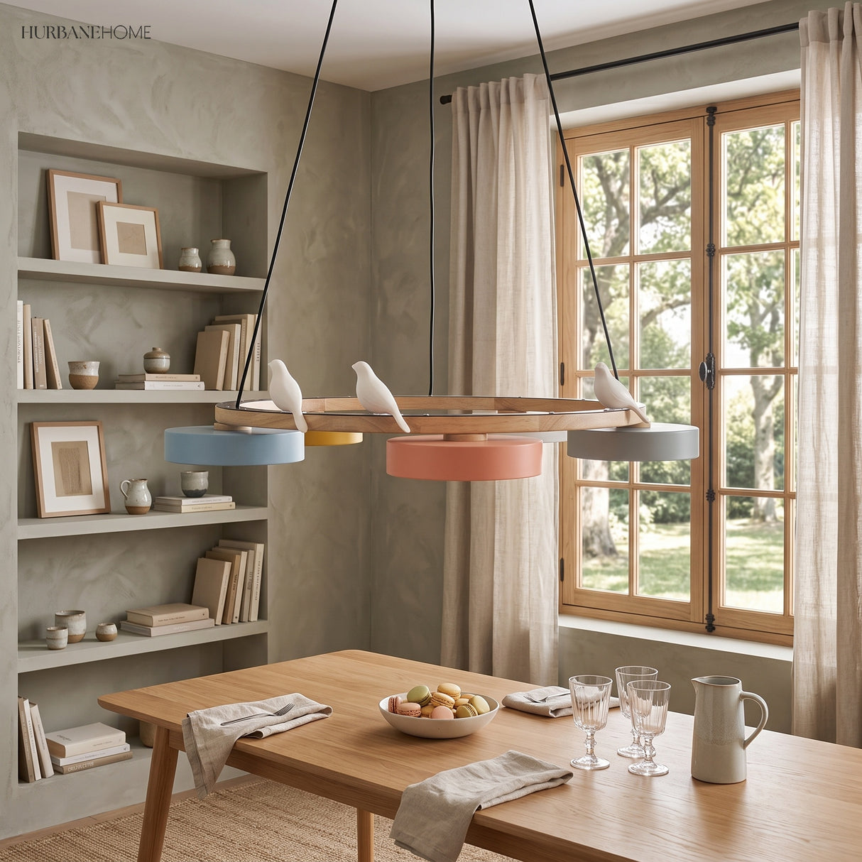 Round wood chandelier with three bird figures above a dining table by shelving