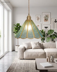 Scalloped glass pendant lit in a bright living room above a pale linen sofa
