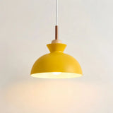 Scandinavian wood pendant light with metal dome shade shown on a plain background