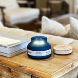 Scented jar candle burning evenly in decorative container