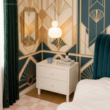 Cream art deco pendant light above a bedroom nightstand