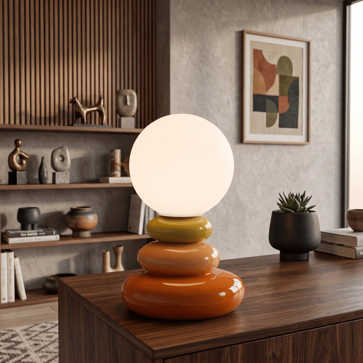 Orange stacked ceramic lamp with round opal shade on a walnut sideboard