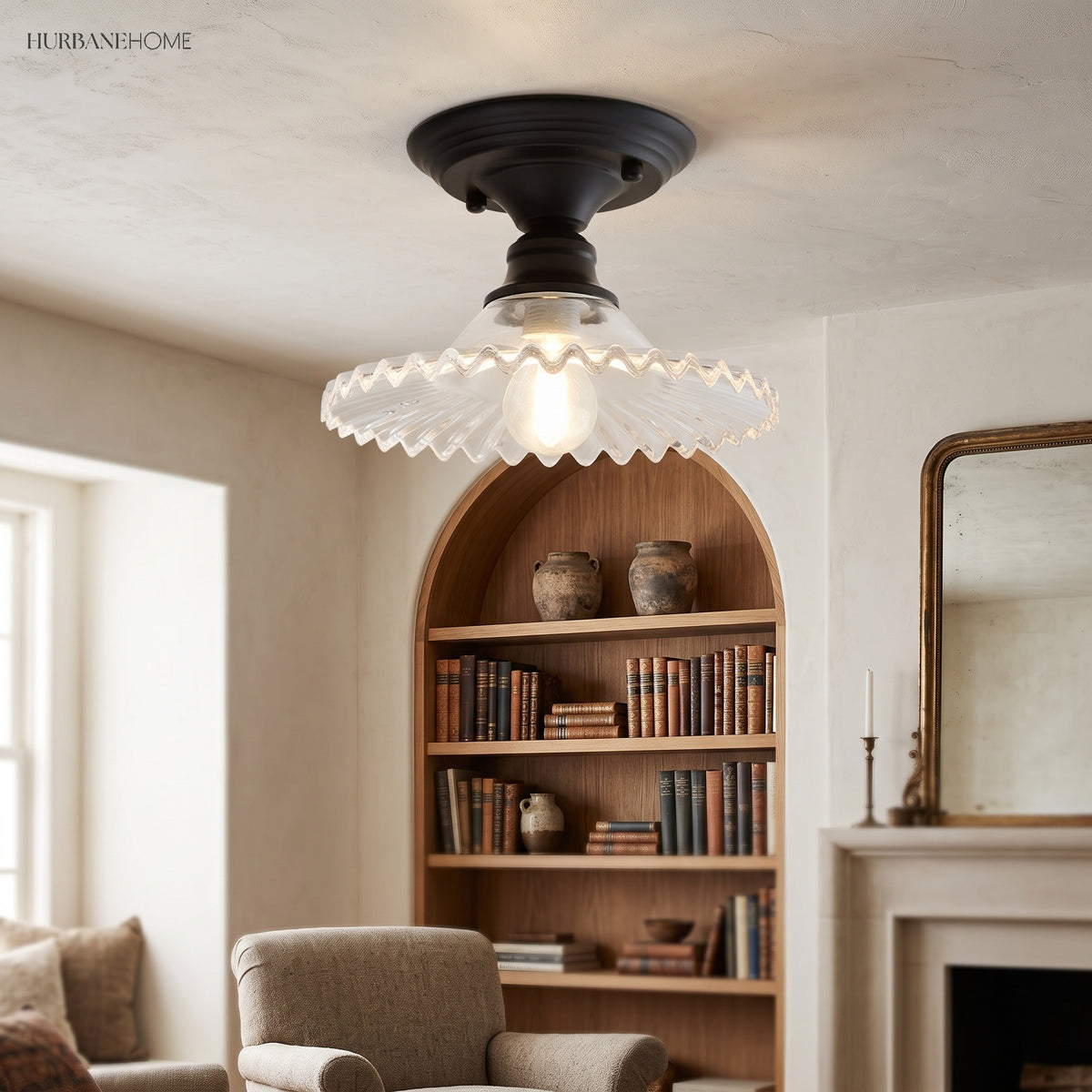 Clear scalloped ceiling light beside a fireplace and bookshelves