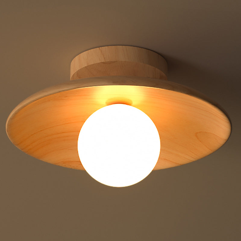 Wood ceiling light lit warm against a dark brown background