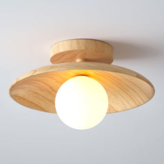 Wood disc ceiling light with the globe unlit on a pale ceiling