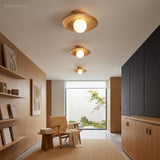 Wood semi flush lights lit above a hallway lined with shelving