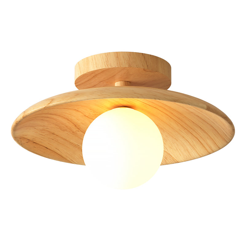 Wood disc ceiling light photographed straight on against grey
