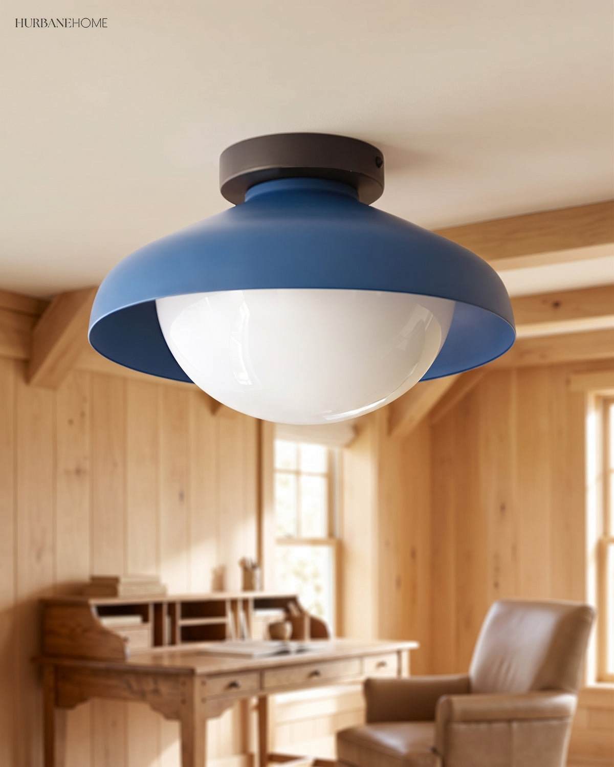 Blue dome ceiling light in a wood panelled home office above a writing desk