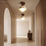 Two stone dome semi flush ceiling lights lighting a neutral hallway