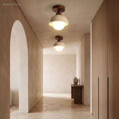 Two stone dome semi flush ceiling lights lighting a neutral hallway