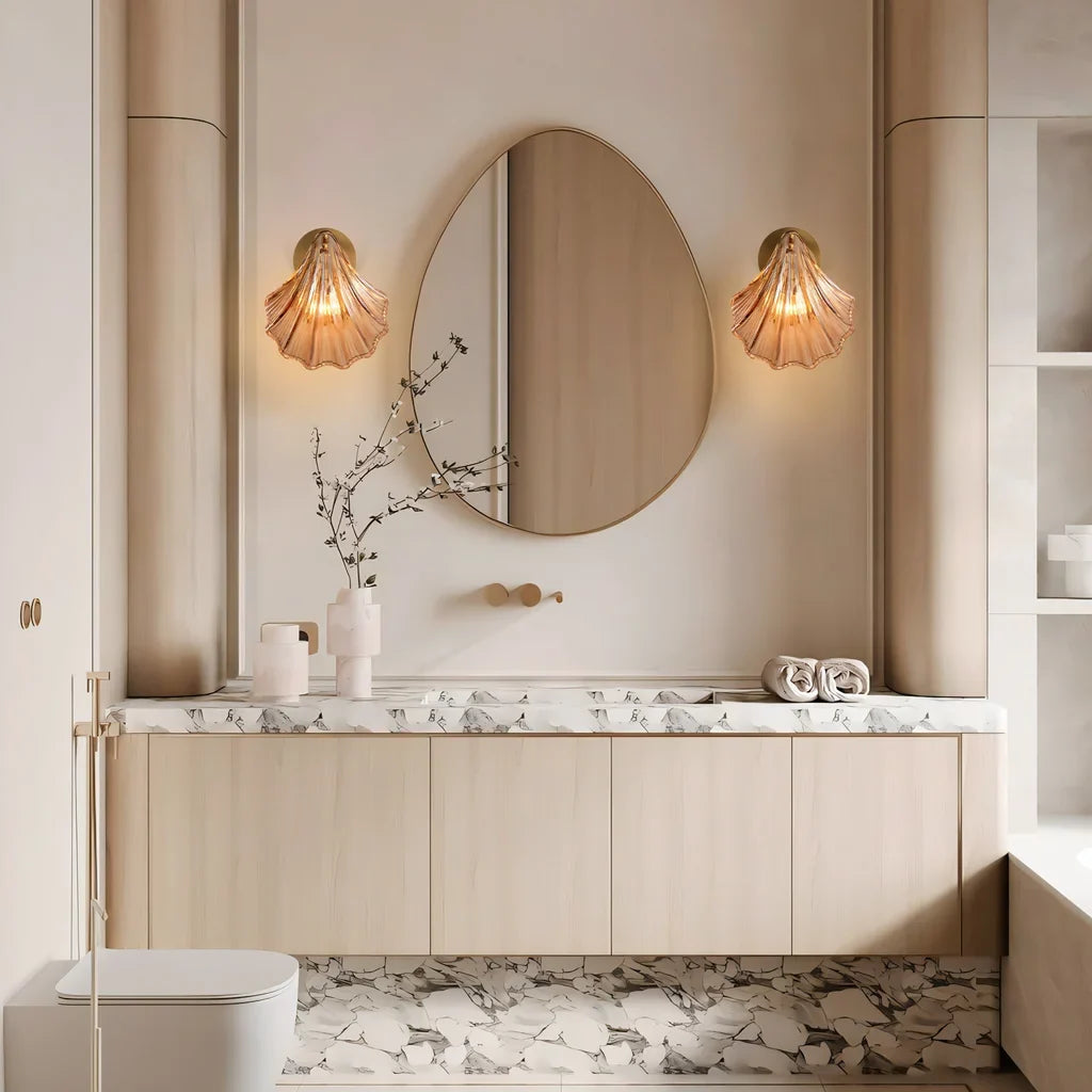 Amber shell wall sconce photographed from a low angle against neutral wall