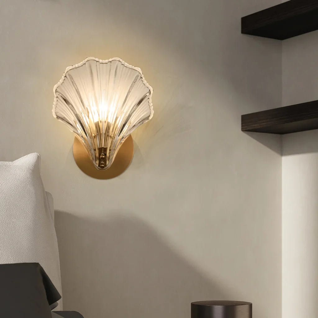 Amber shell wall sconce shown lit from a three quarter viewpoint