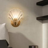 Amber shell wall sconce shown lit from a three quarter viewpoint