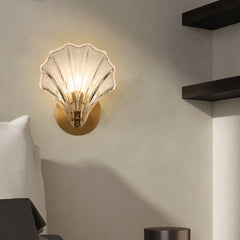Amber shell wall sconce shown lit from a three quarter viewpoint