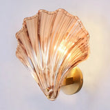 Amber glass shell shade variant on the brass wall sconce base