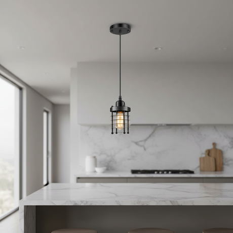 A single black pendant light with a wire cage shade hangs over a modern kitchen island with a white marble countertop and backsplash.
