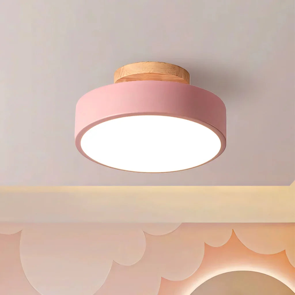 White macaron ceiling light shown against a plain studio background from below