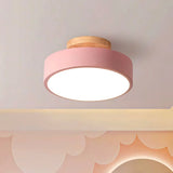 White macaron ceiling light shown against a plain studio background from below
