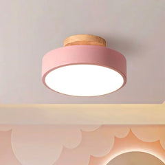 White macaron ceiling light shown against a plain studio background from below