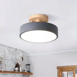 Green macaron ceiling light shown against a plain studio background from below