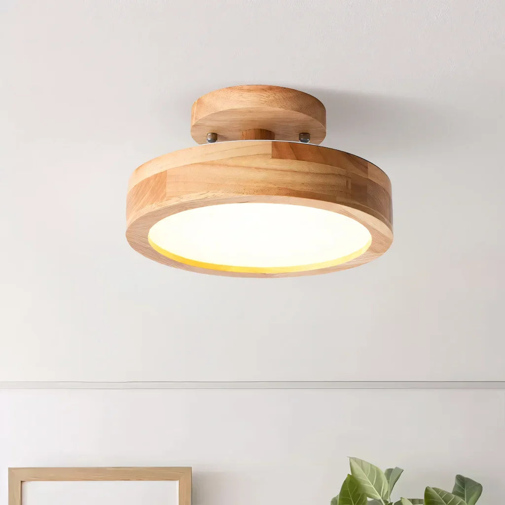 Pink macaron ceiling light shown against a plain studio background from below