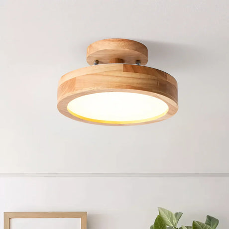 Pink macaron ceiling light shown against a plain studio background from below