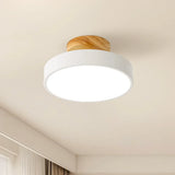 Natural wood finish ceiling light shown against a plain studio background from below