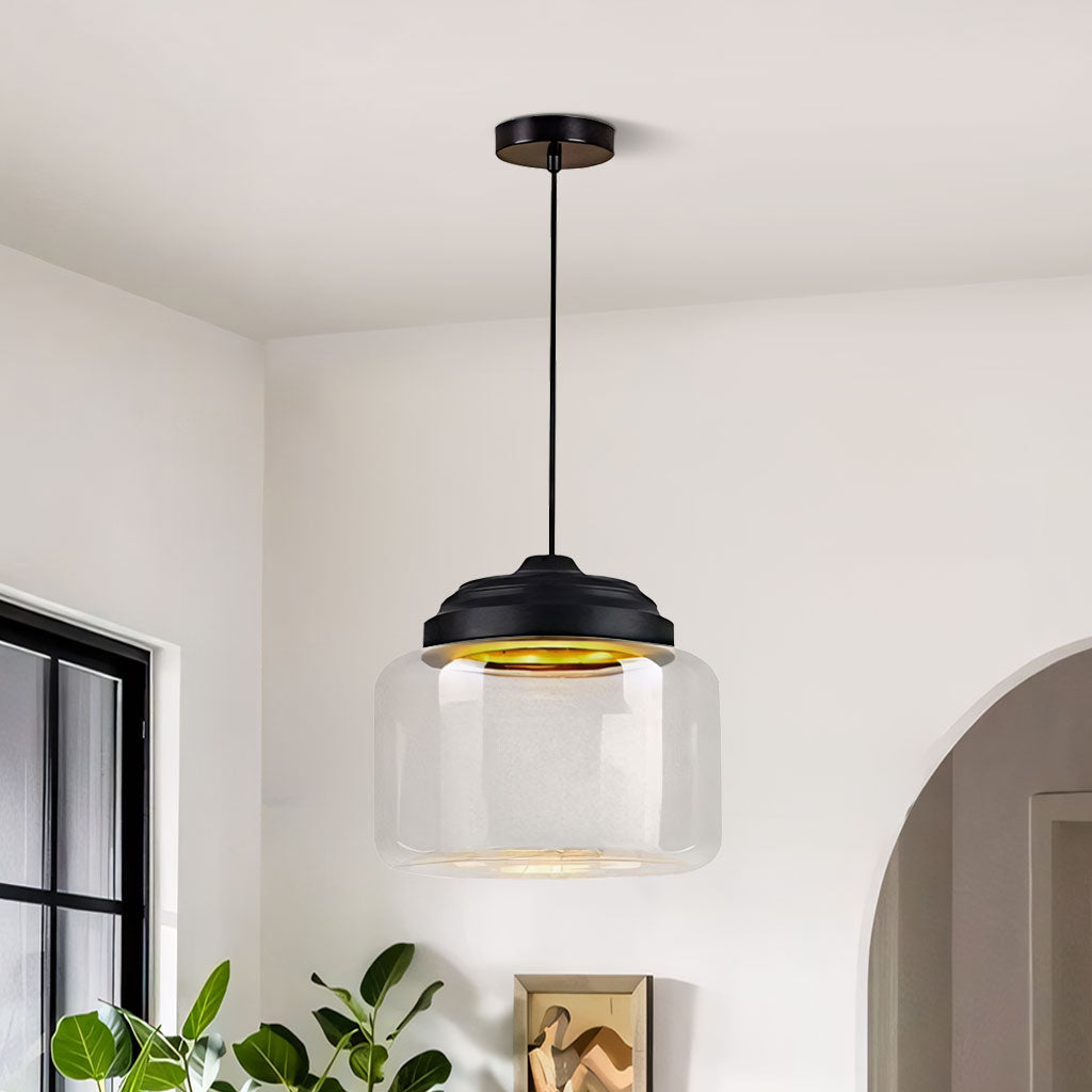 Empty clear glass drum pendant with black stepped cap suspended from a ceiling rose
