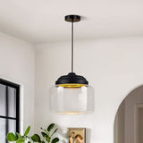 Empty clear glass drum pendant with black stepped cap suspended from a ceiling rose