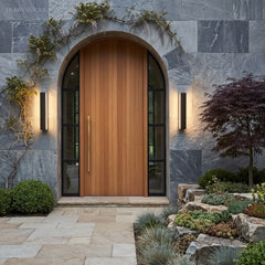 Pair of linear lights flanking an arched timber front door in stone cladding