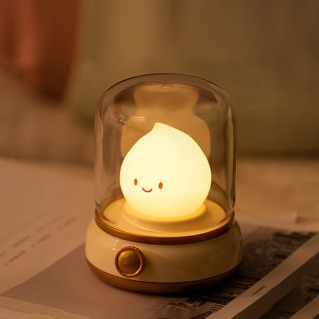 Cream based night light standing on an open magazine with warm light on the page