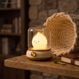 Flame night light beside a coiled knitted basket on a rustic wooden table