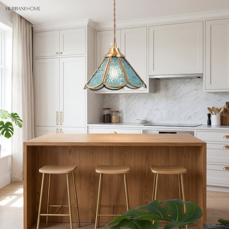 Blue panelled glass pendant hanging above a timber kitchen island with stools