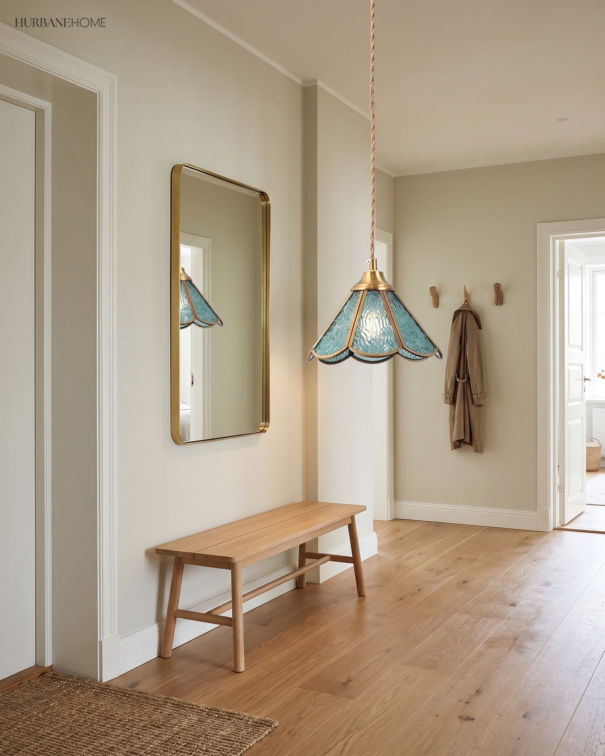 Two small glass pendants hung along a pale hallway above a timber bench