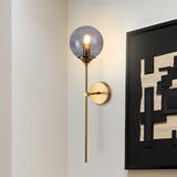 Smoke grey glass globe wall sconce close view on brass