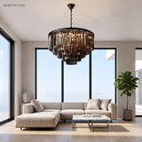 Smoky grey crystal chandelier hanging in a bright modern living room above a sofa