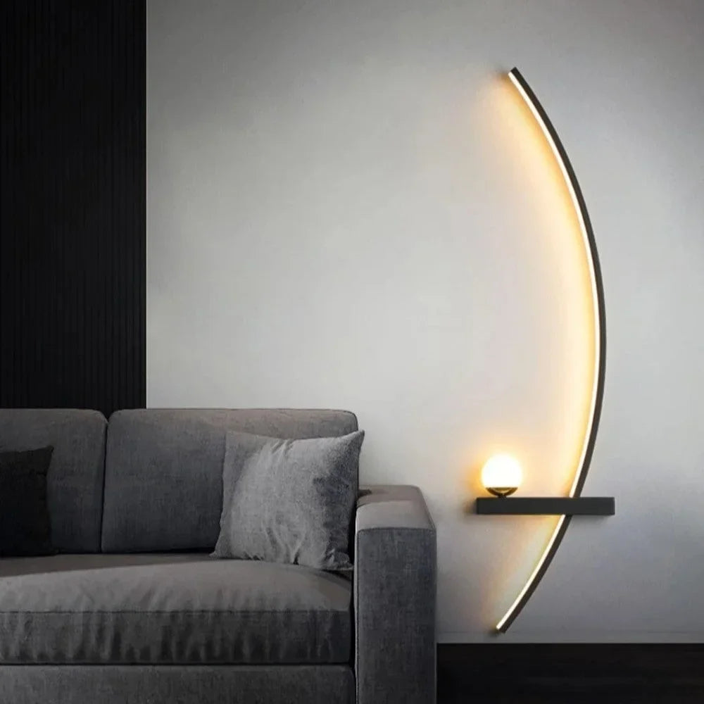 Linear wall sconce lighting a wall above a grey fabric sofa