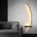 Linear wall sconce lighting a wall above a grey fabric sofa