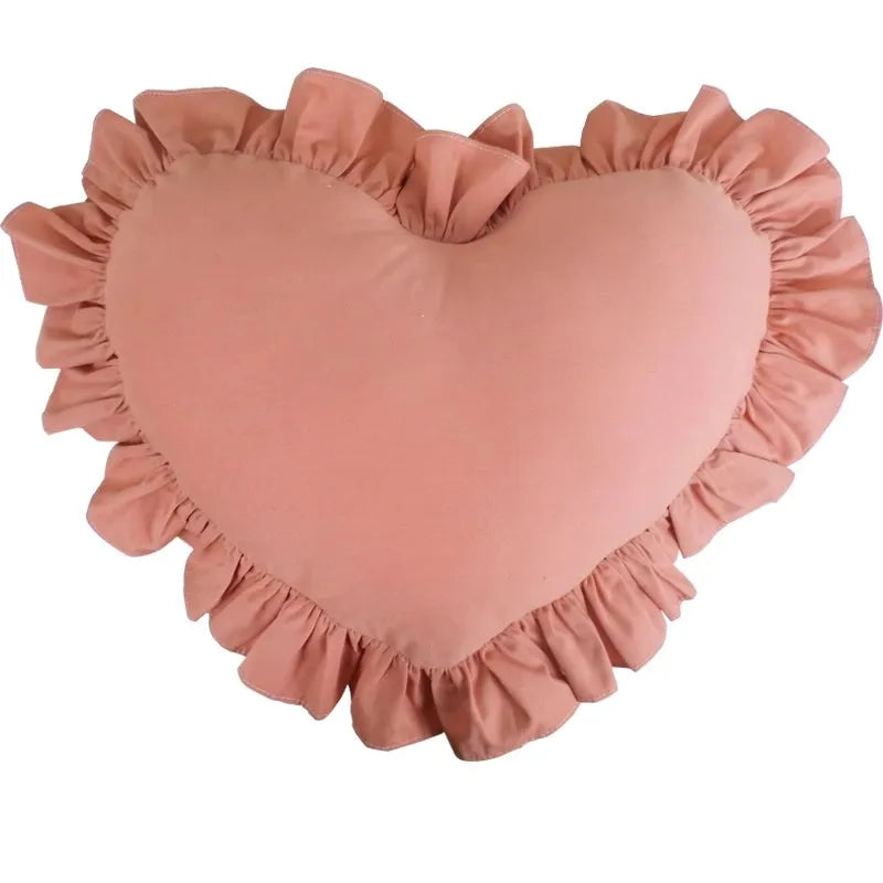 Plush ruffled accent designed as soft heart shaped pillow for bedroom