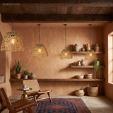 Woven rattan bell lantern glowing warm under a timber pergola
