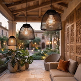 Row of woven pendant lanterns lit above an outdoor dining table
