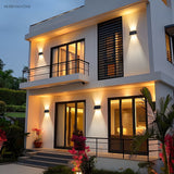 Solar wall light with angled panel casting two beams on stone