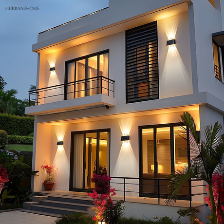 Solar wall light with angled panel casting two beams on stone