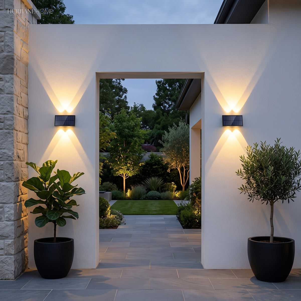 Row of solar wall lights lighting a modern house facade at night