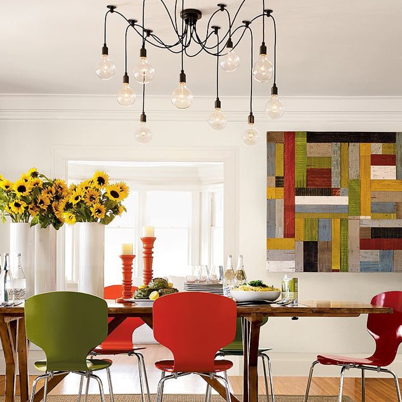 Spider chandelier lit above a dining table set with sunflowers