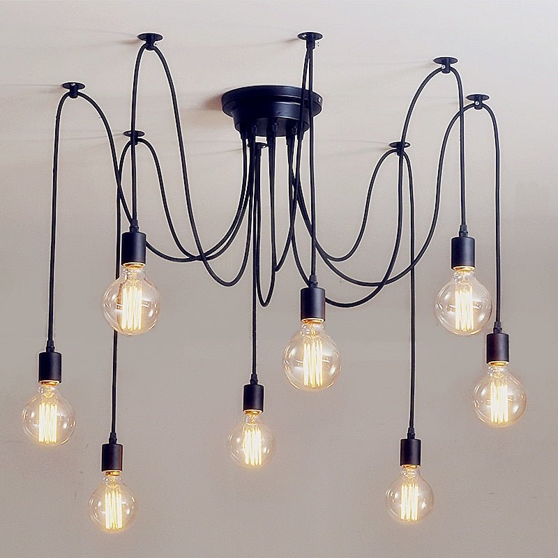 Black spider chandelier with eight cables and bare bulbs on a white ceiling